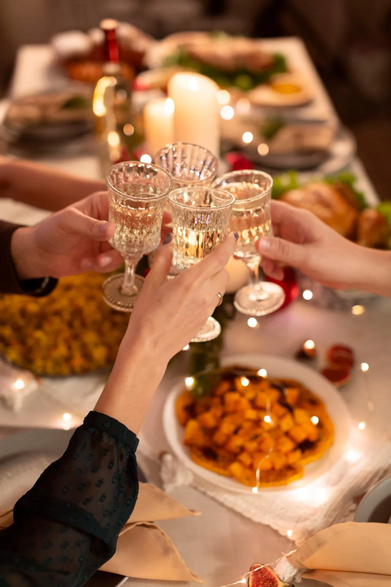 Friends toasting at a candlelit birthday celebration