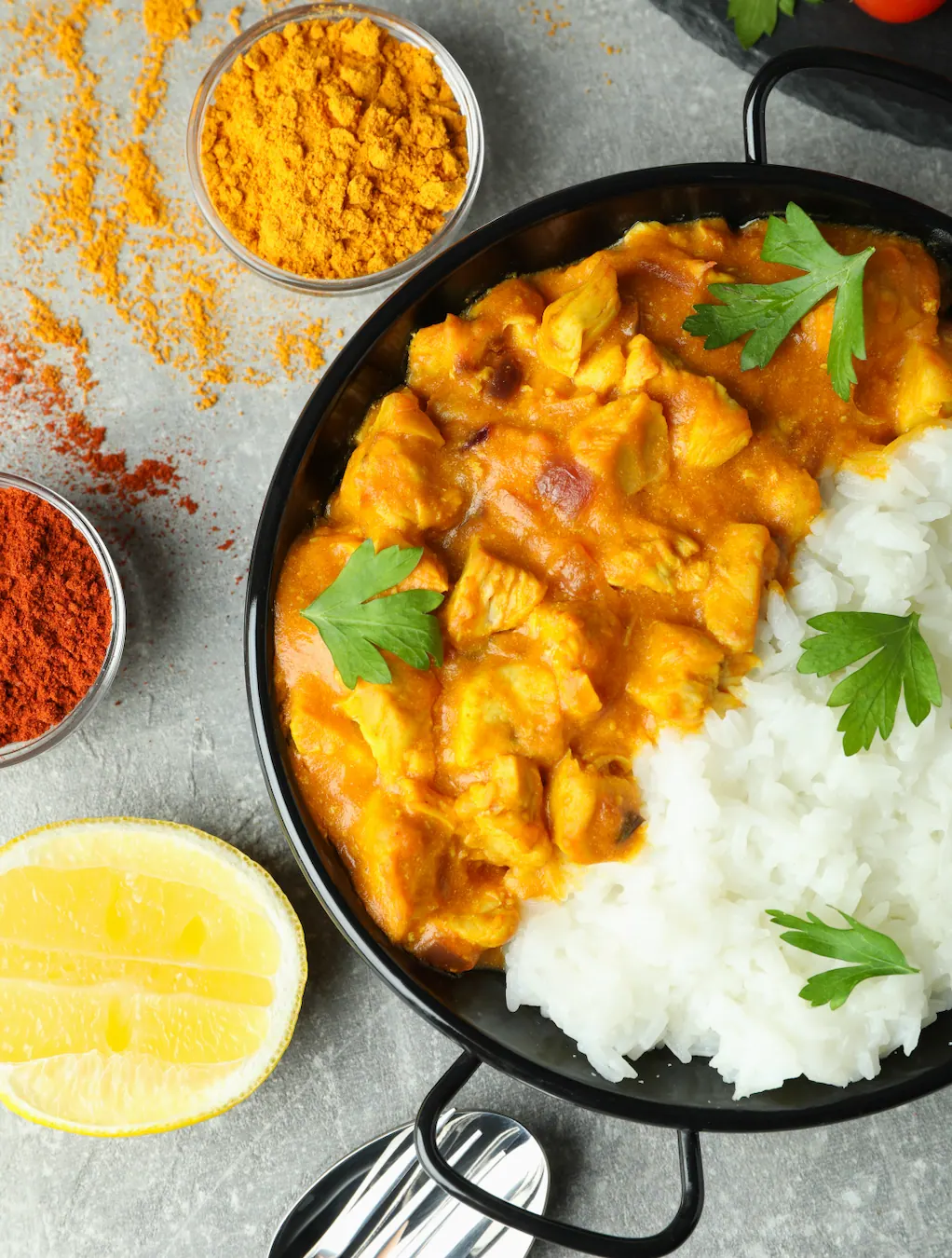 Creamy chicken curry with steamed rice, turmeric and paprika