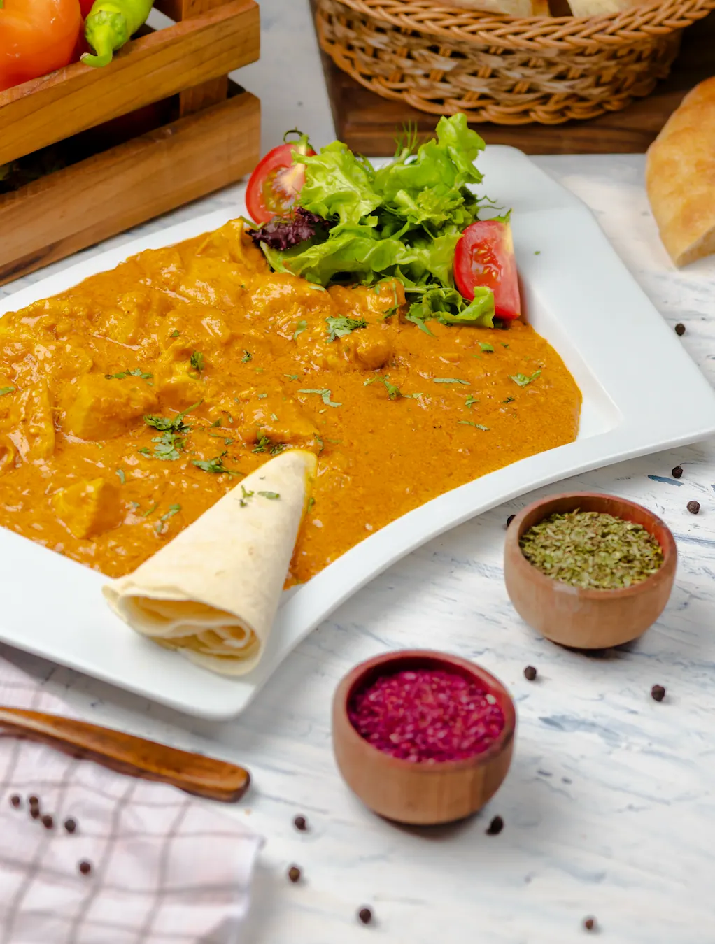 Mild chicken curry with side salad and a rolled chapati