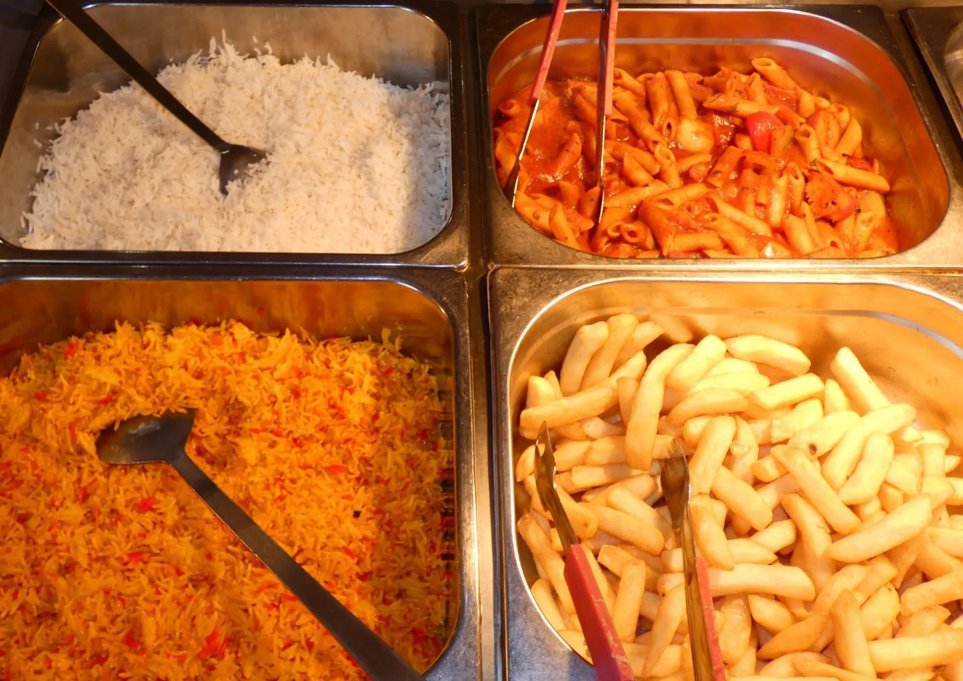 Buffet trays of rice, pasta and chips