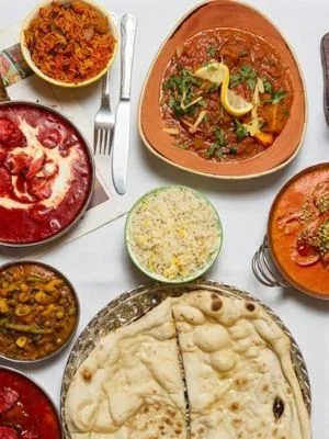 Spread of Amantola dishes with naan and rice
